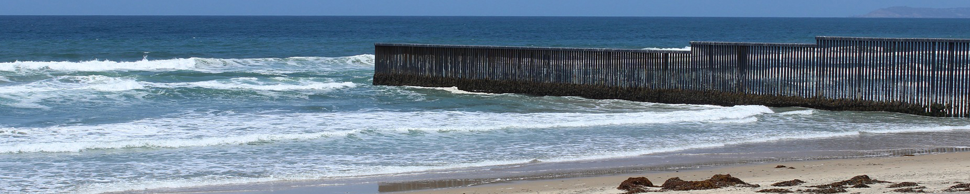 border fence in ocean between Mexico and San Diego